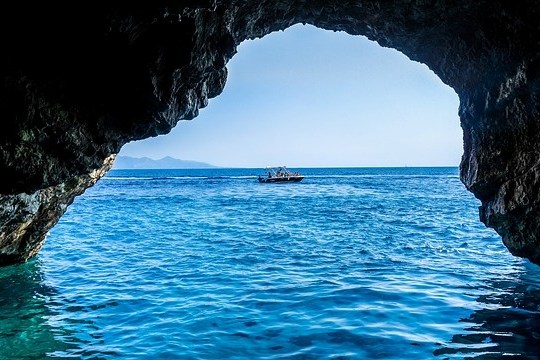 a cave next to a body of water