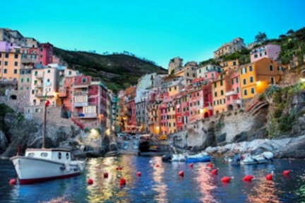 a small boat in a body of water with a city in the background