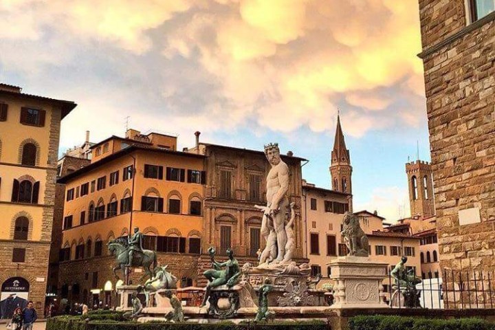 a group of people in front of a brick building