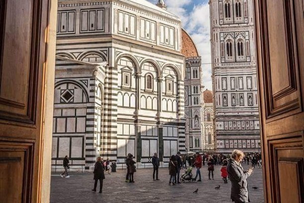 a group of people walking in front of a building